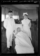 Portrait of R. E. Jenkins with child and woman in nurse's uniform