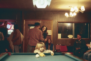 Child playing on a pool table