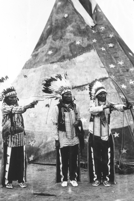 Entertainers pose in front of tipi in Wyoming