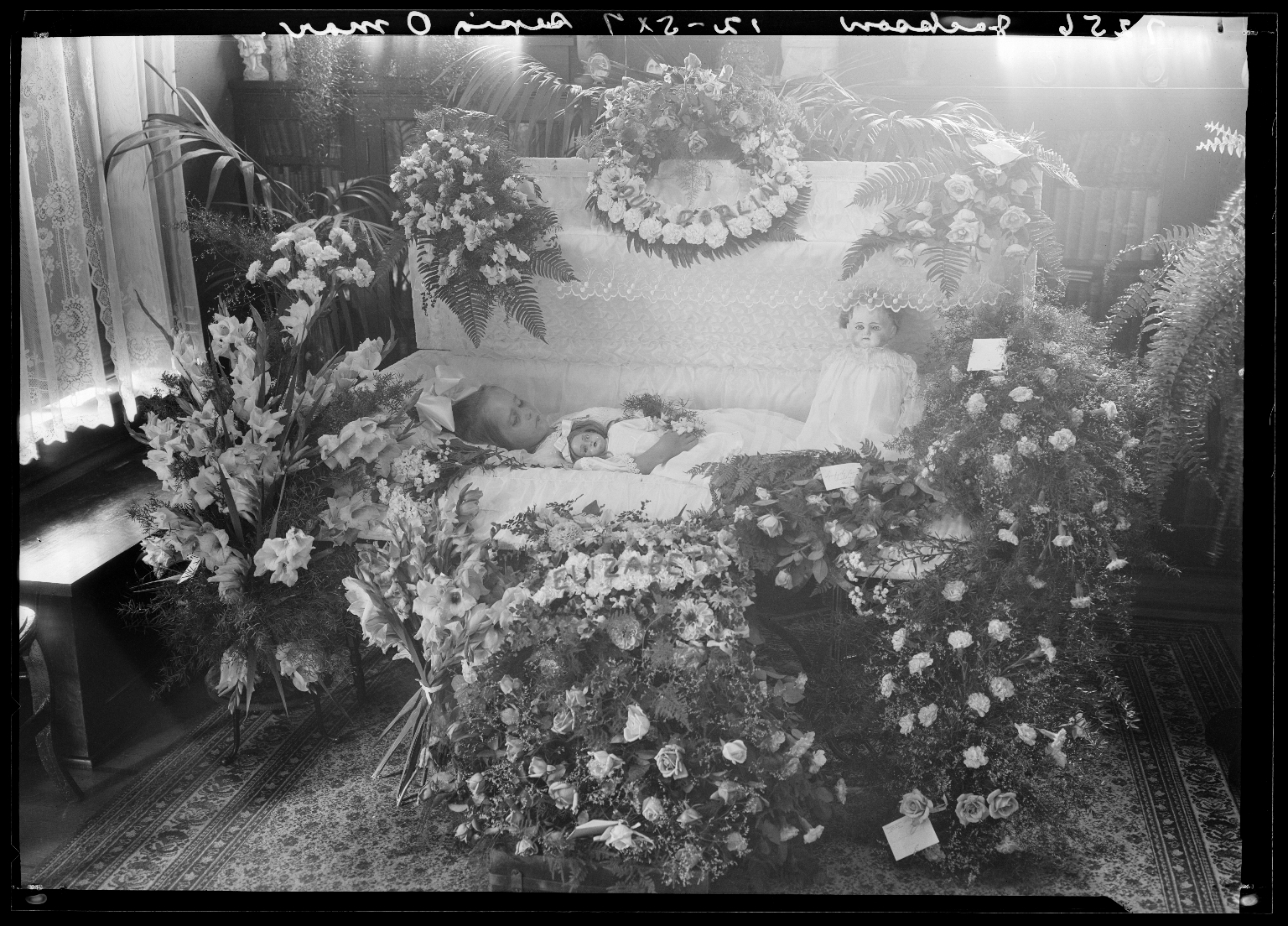 Portraits of deceased child of Jackson (Erickson) in coffin
